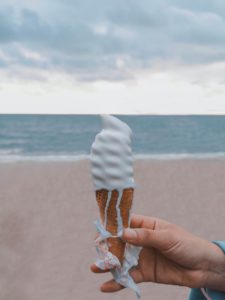 person holding vanilla ice cream on cone