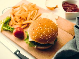 burger and fries on a cutting board