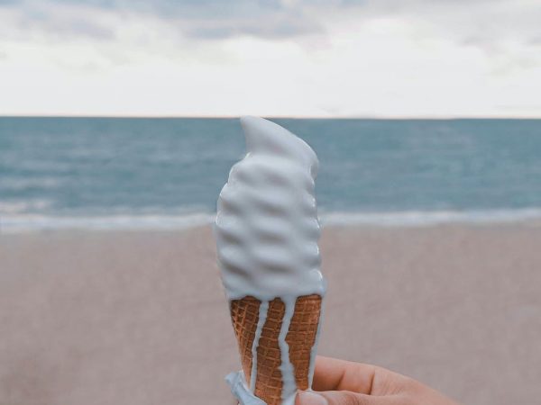 person holding vanilla ice cream on cone